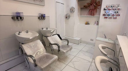 Modern wash stations and chairs at HairbyBryanMurphy in Glasgow, Scotland, GB showcasing sleek salon design.