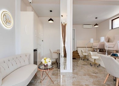 Chic interior of Glow Nails & Academy, Бургас, Бургас, BG with plush chairs and sleek nail stations.