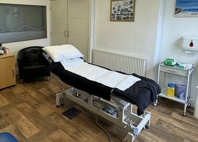 Massage therapy room at CP Sports Massage Therapy, Kenfig Hill, Wales, GB, featuring a comfortable treatment bed.