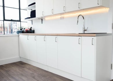 Modern salon sink and white cabinets at Logvina Hair, London, England, GB, showcasing sleek design.