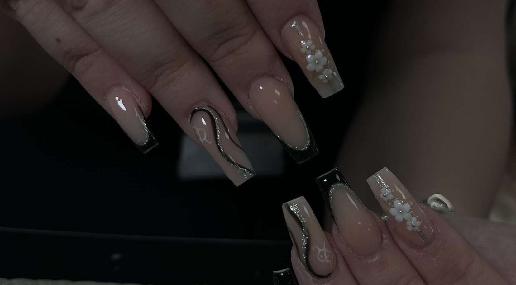 Elegant floral nail art by Ink and Polish, Barnsley, England, GB, showcasing intricate designs and glossy finish.