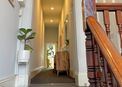 Elegant hallway at Choojai Thai Massage, Richmond, Victoria, AU, featuring plants and wooden decor.