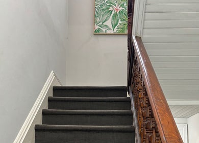 Elegant staircase with art leading to Choojai Thai Massage in Richmond, Victoria, AU.
