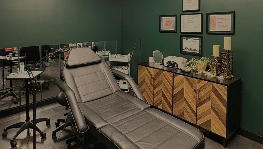 Elegant Aesthetics' calming treatment room in Calgary, Alberta, CA with plush reclining chair and decor.