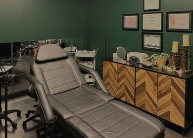 Elegant Aesthetics' calming treatment room in Calgary, Alberta, CA with plush reclining chair and decor.
