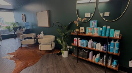 Interior of Elegant Aesthetics in Calgary, Alberta, CA, featuring stylish seating and beauty products display.