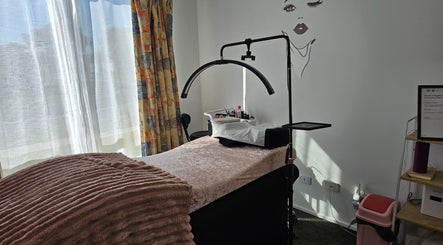Cozy treatment room at Courtney's Classics, Melbourne, Victoria, AU with a plush bed under natural light.