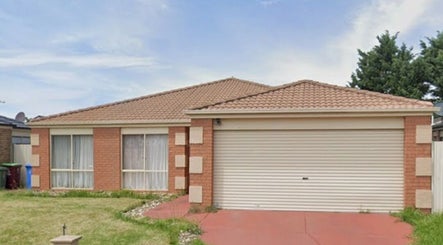 Front view of Courtney's Classics in Melbourne, Victoria, AU showcasing a charming brick structure and garage.