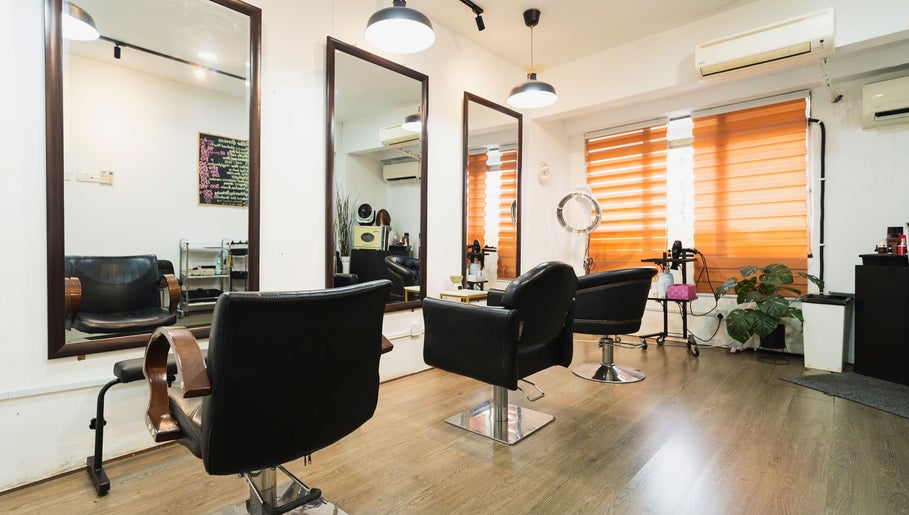 Modern salon interior at Bliss Salon in Kuala Lumpur, Wilayah Persekutuan Kuala Lumpur, MY, with stylish chairs.