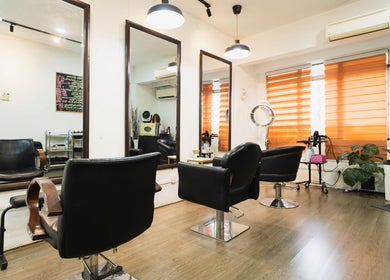 Modern salon interior at Bliss Salon in Kuala Lumpur, Wilayah Persekutuan Kuala Lumpur, MY, with stylish chairs.