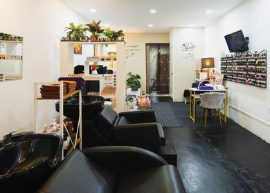 Elegant interior of Bliss Salon in Kuala Lumpur, featuring nail polish racks and cozy seating areas.