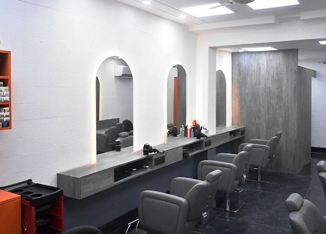Modern salon interior with chic chairs and mirrors at The Specialist Unisex Salon, New Delhi, Delhi, IN.