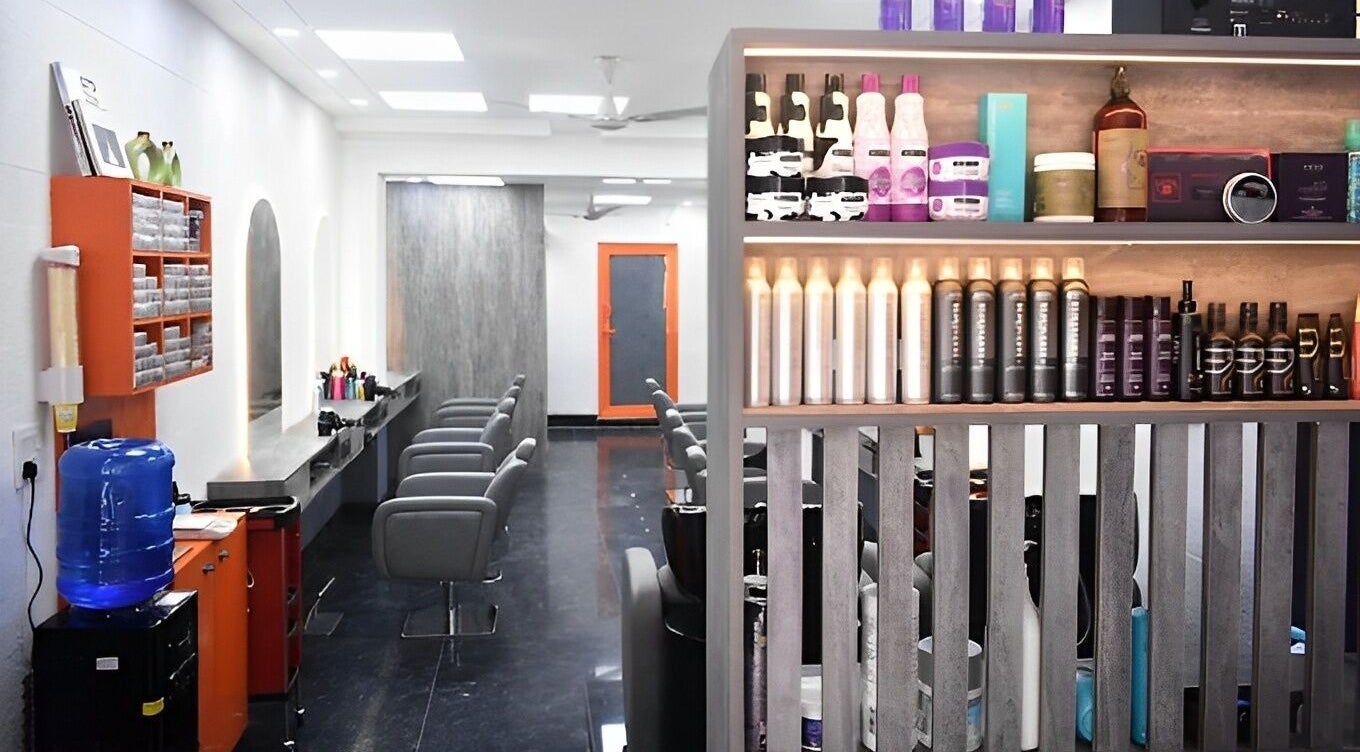 Modern interior of The Specialist Unisex Salon in New Delhi, Delhi, IN featuring stylish chairs and product display.