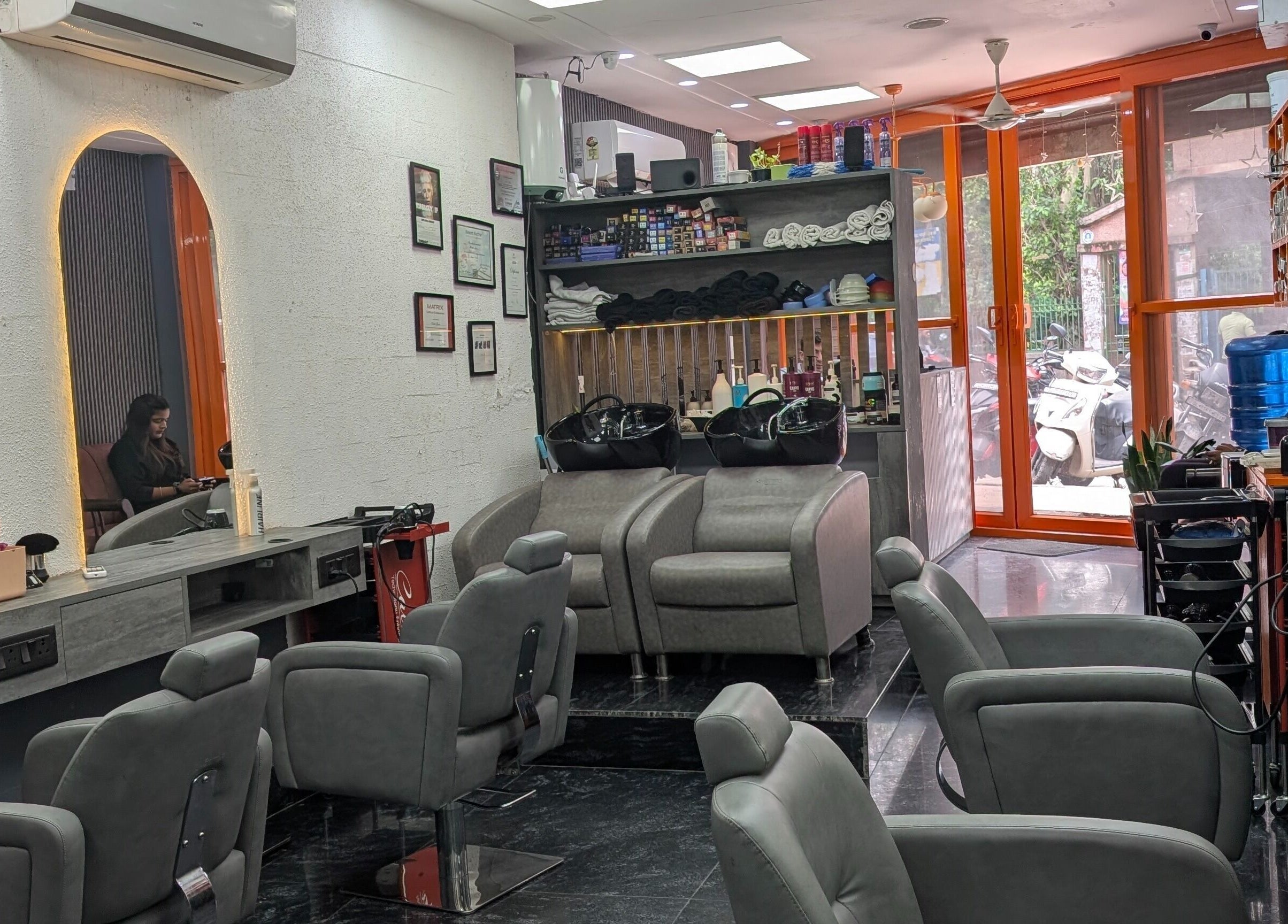 Interior of The Specialist Unisex Salon in New Delhi, showcasing modern chairs and stylish decor.