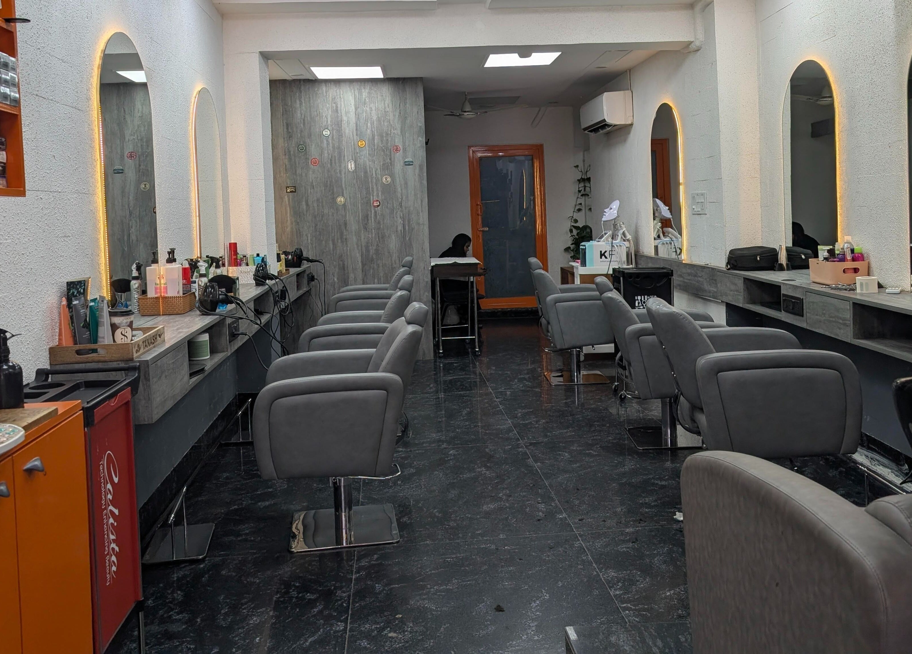 Modern salon interior at The Specialist Unisex Salon, New Delhi, Delhi, IN, with stylish chairs and mirrors.