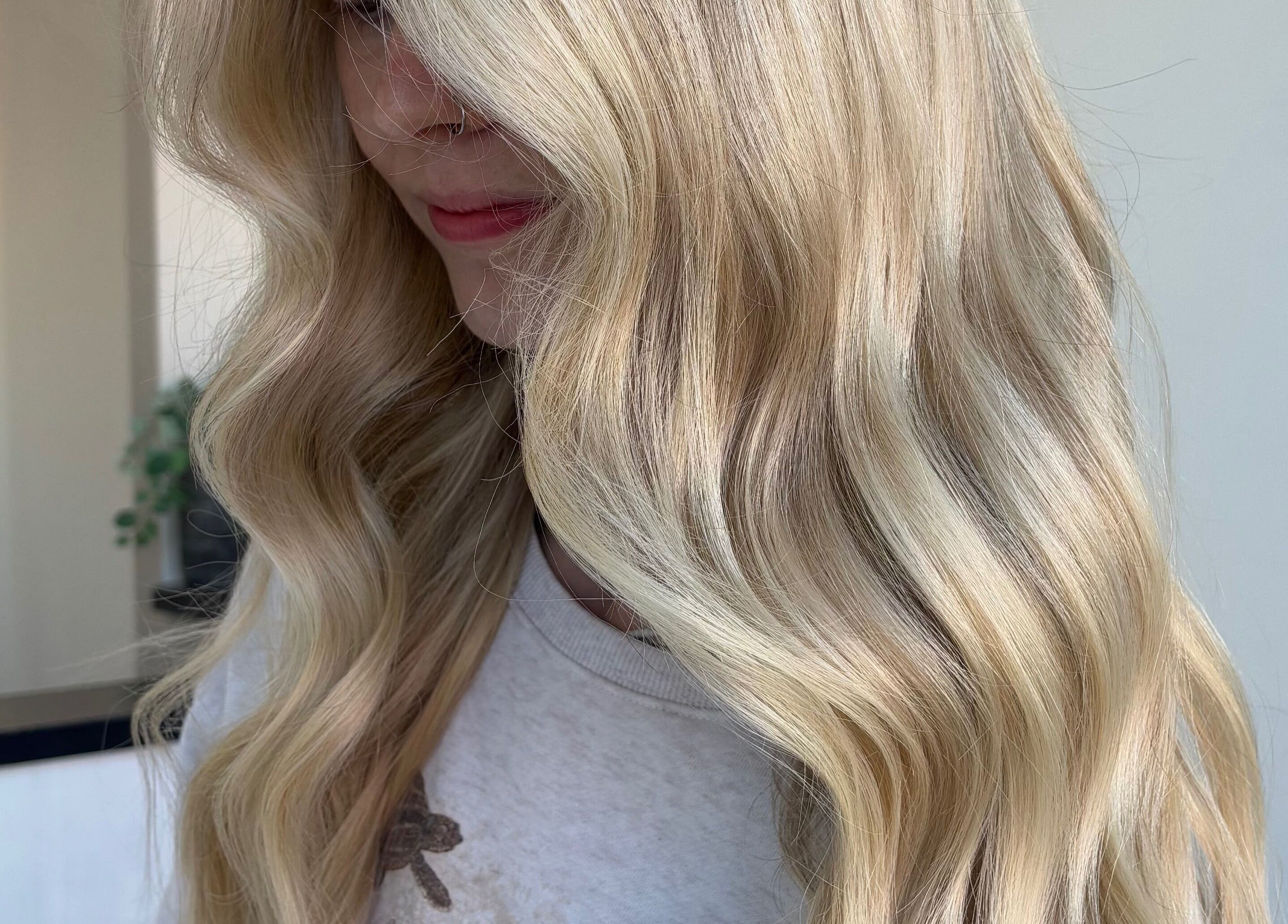 Blonde woman with wavy hair styled at Hair by Emma Sturt, Beenleigh, Queensland, AU.
