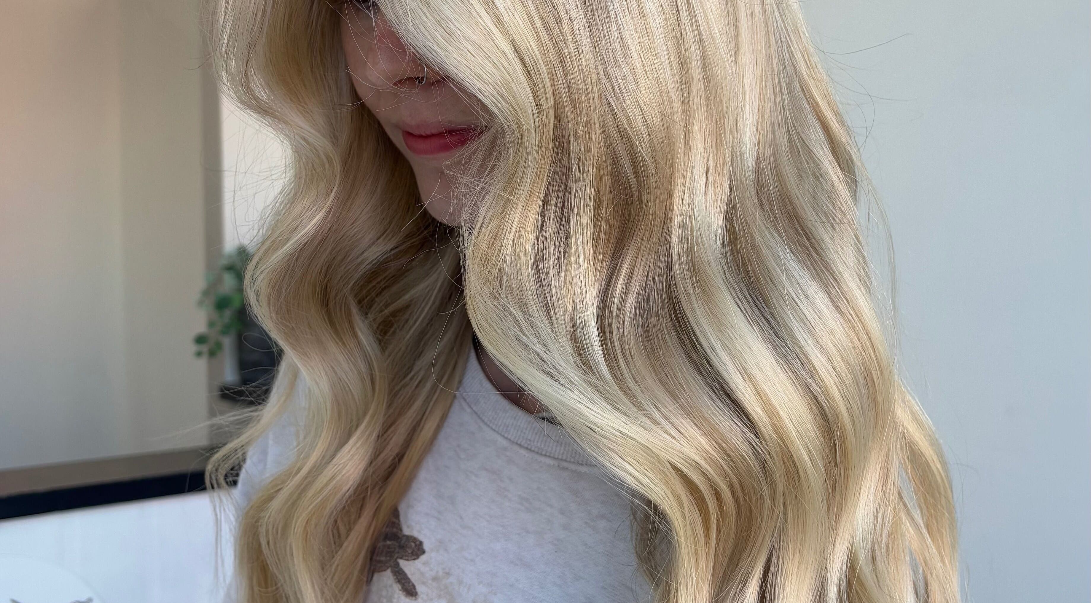 Blonde woman with wavy hair styled at Hair by Emma Sturt, Beenleigh, Queensland, AU.