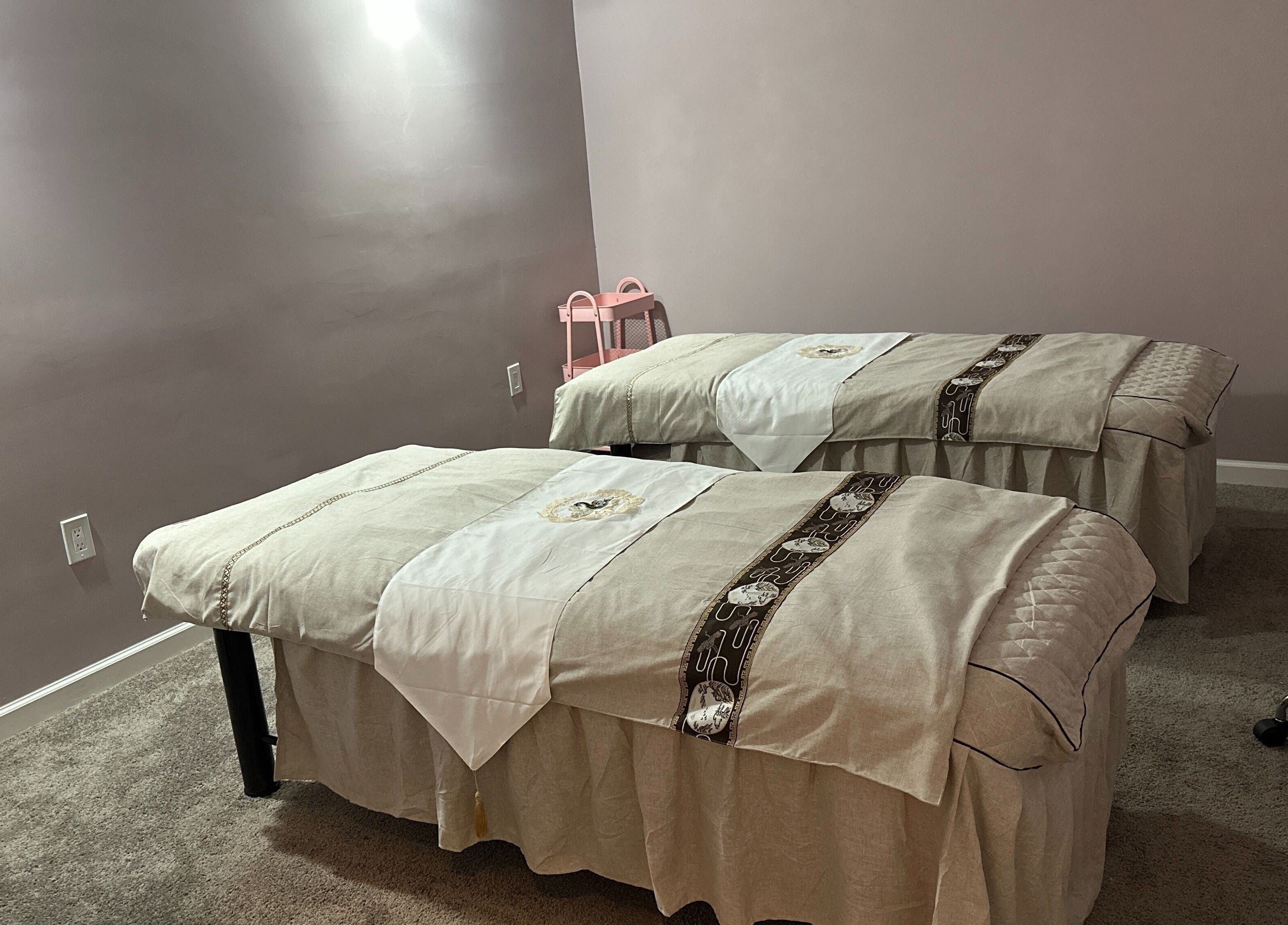 Massage room at U Mi Massage, Lenoir City, Tennessee with two tables and calming decor.