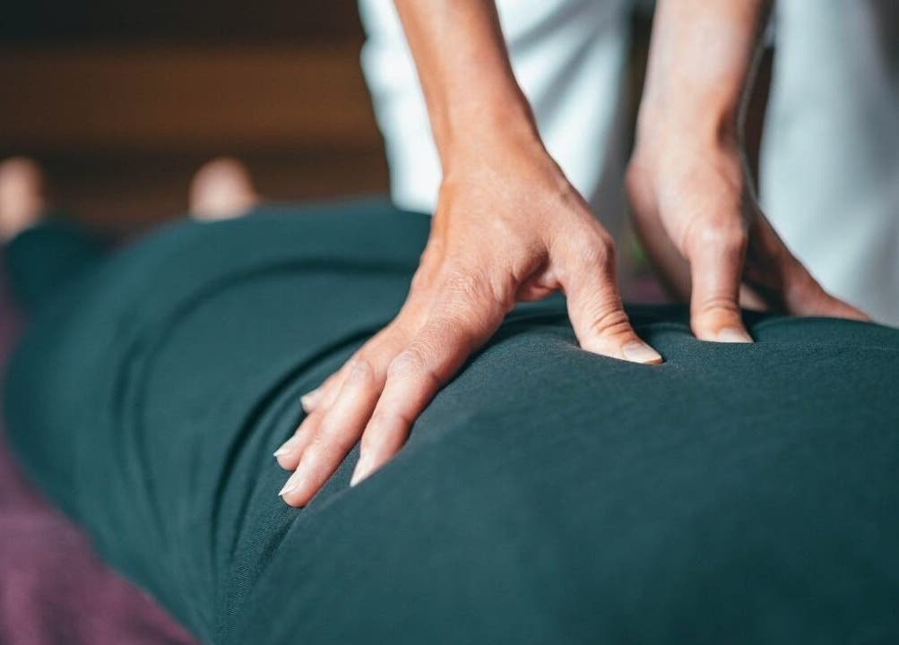 Hands providing massage therapy at Fusion Elite Performance Therapy, Aylesbury, England, GB.