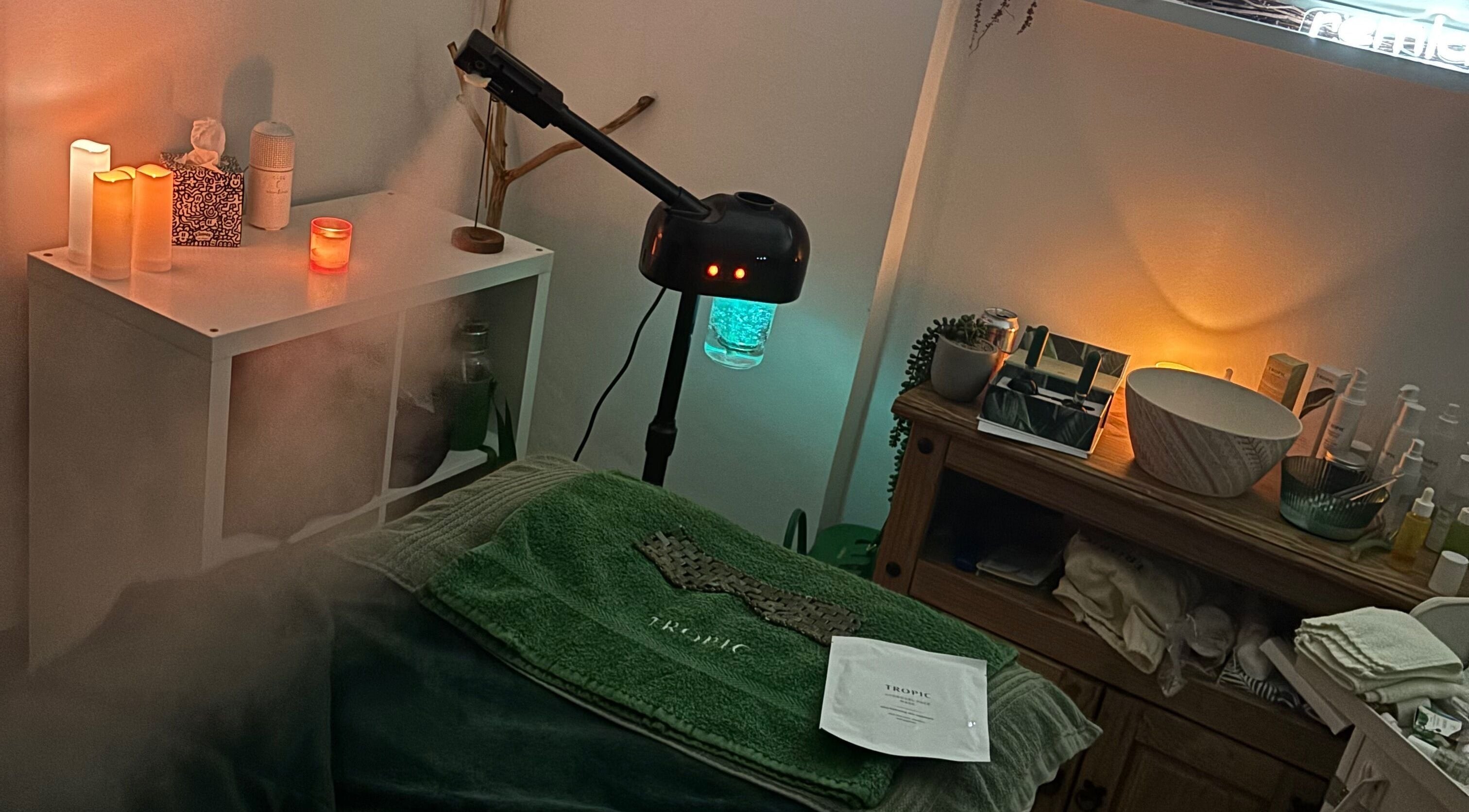 Cozy spa room at Ethical Beauty By Leeanne, Whitburn, Scotland, GB with candles and treatment setup.