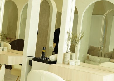 Modern salon station at Couture Studio in Taguig, Metro Manila, PH with mirrors and minimalist decor.