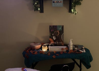 Cozy relaxation spot at Bliss & Beauty by Nikki at Serenity, Leek, England, GB, with candles and beauty products.
