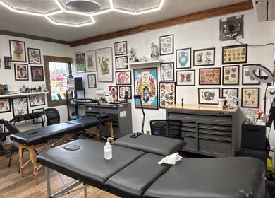 Sierra’s Tattoos studio room in Moncton, New Brunswick, CA with tattoo art displays and workstations.