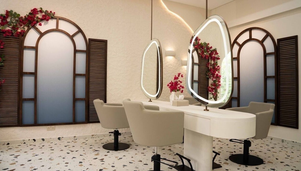 Modern salon interior at Evaya Beauty Lounge in Dubai, Dubai, AE featuring elegant mirrors and plush chairs.