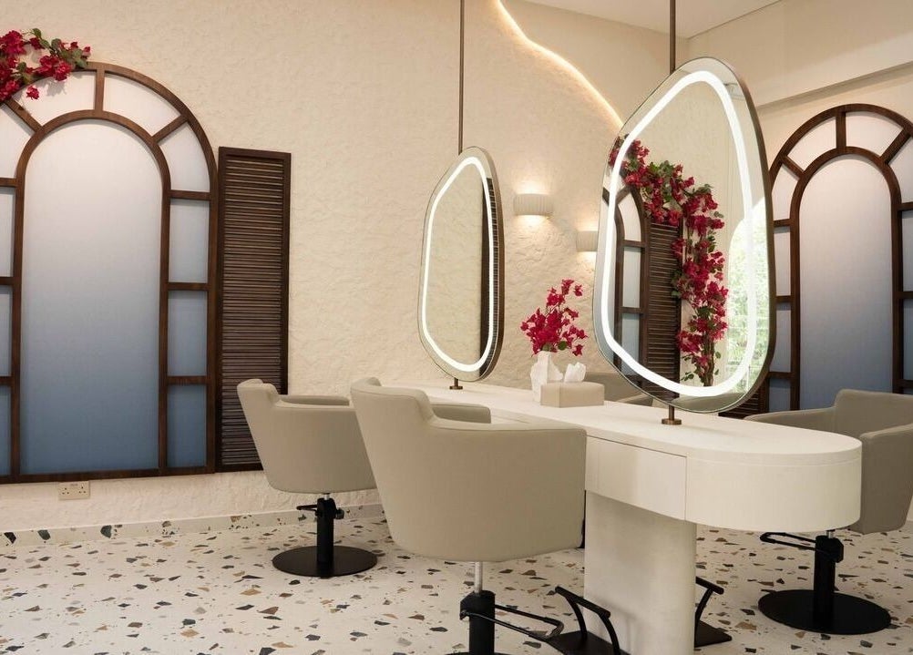 Modern salon interior at Evaya Beauty Lounge in Dubai, Dubai, AE featuring elegant mirrors and plush chairs.