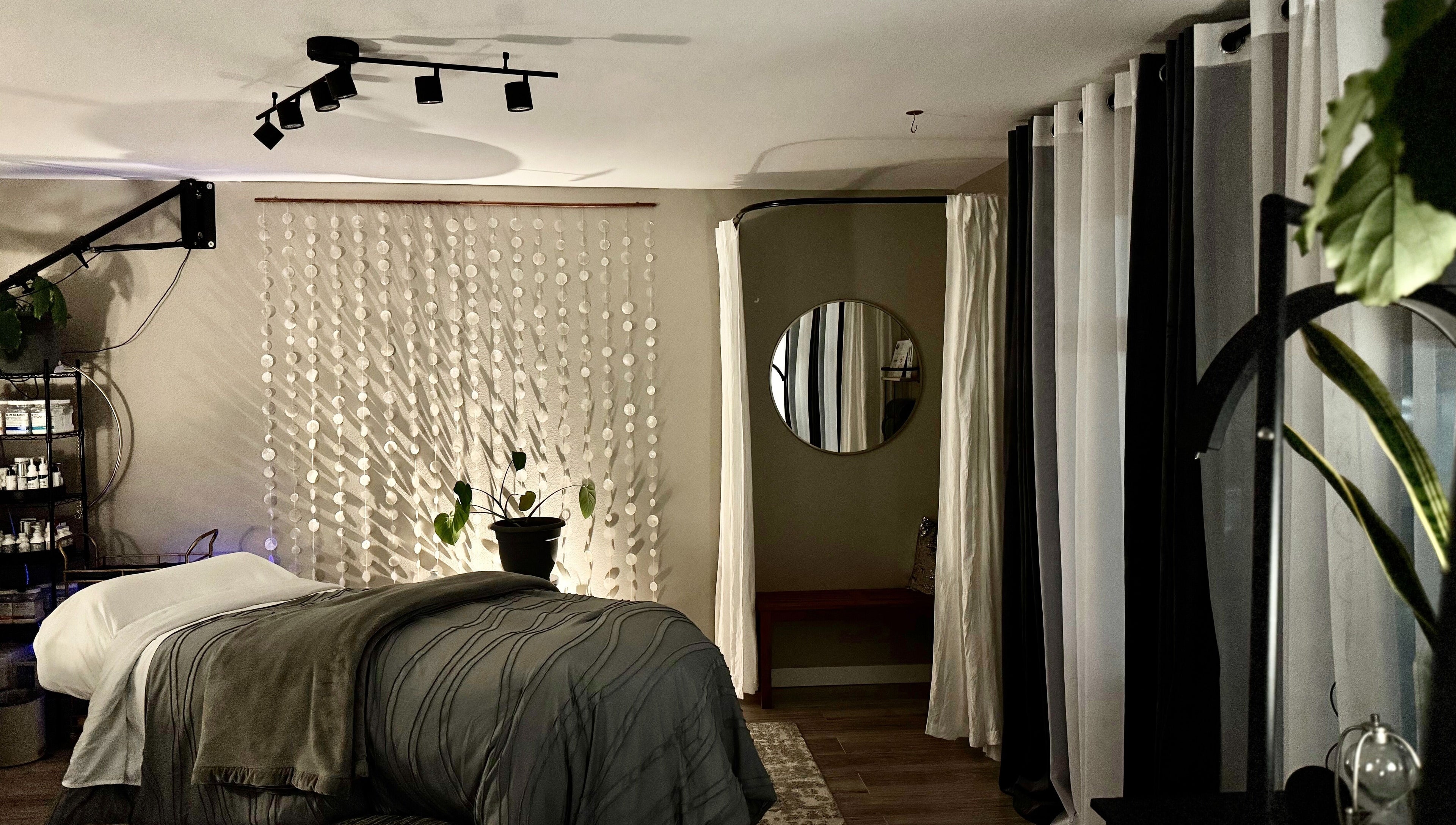 Relaxing treatment room at Essential Luxuries Day Spa in Snohomish, Washington, US with cozy decor.