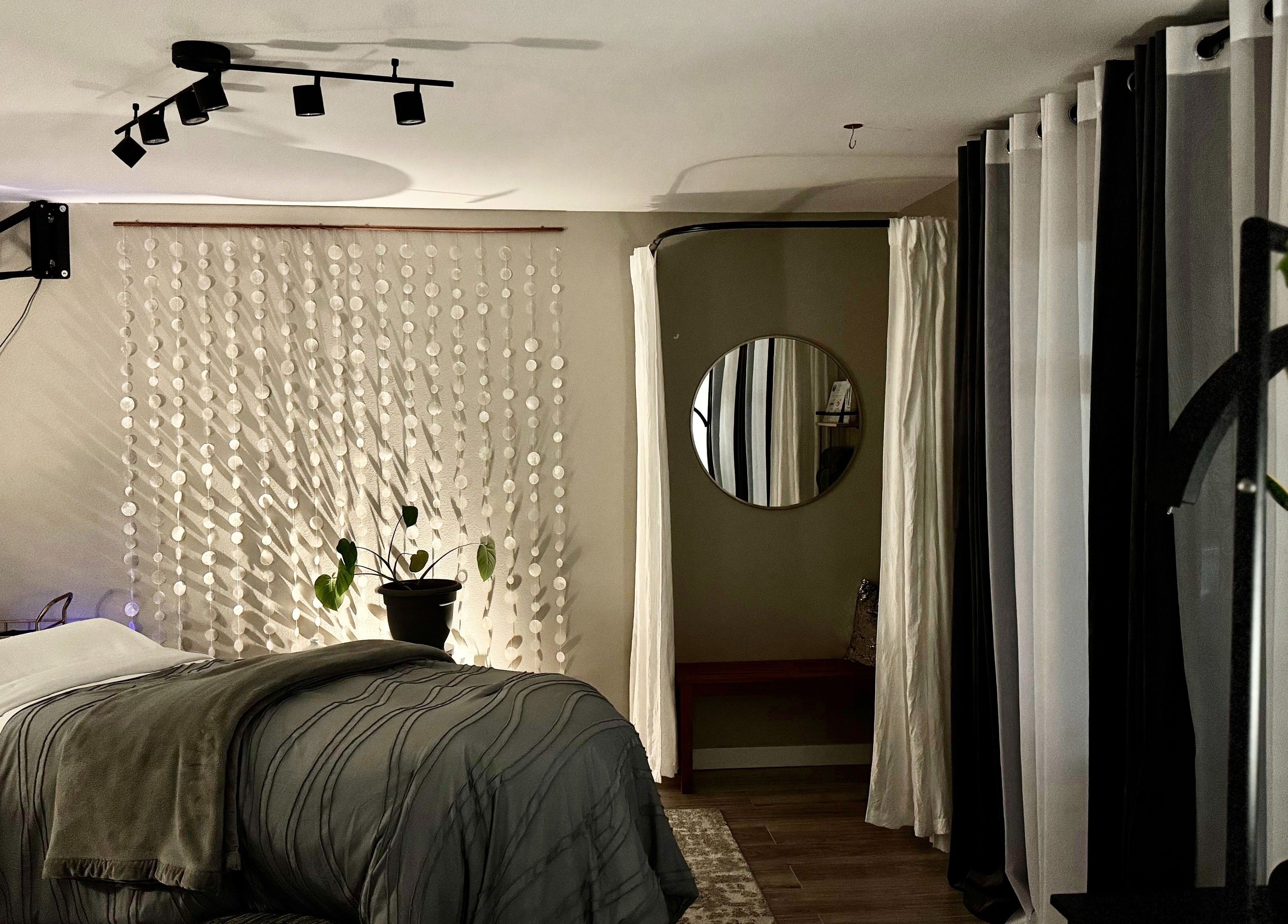 Relaxing treatment room at Essential Luxuries Day Spa in Snohomish, Washington, US with cozy decor.