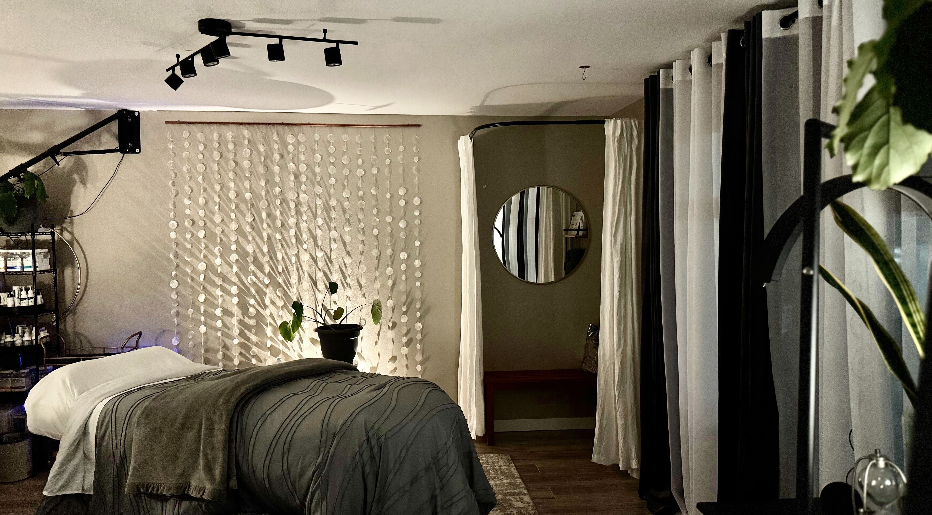Relaxing treatment room at Essential Luxuries Day Spa in Snohomish, Washington, US with cozy decor.