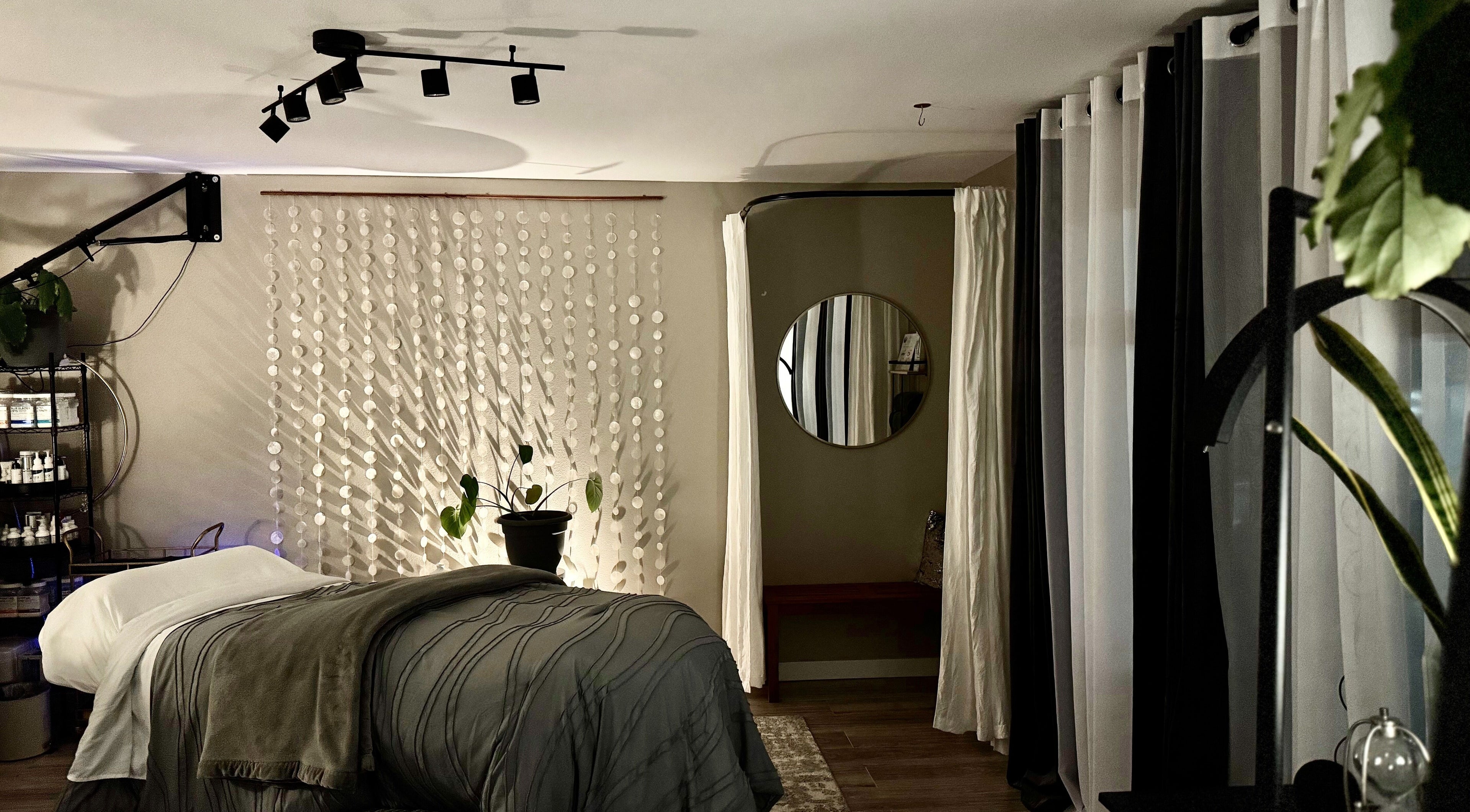 Relaxing treatment room at Essential Luxuries Day Spa in Snohomish, Washington, US with cozy decor.