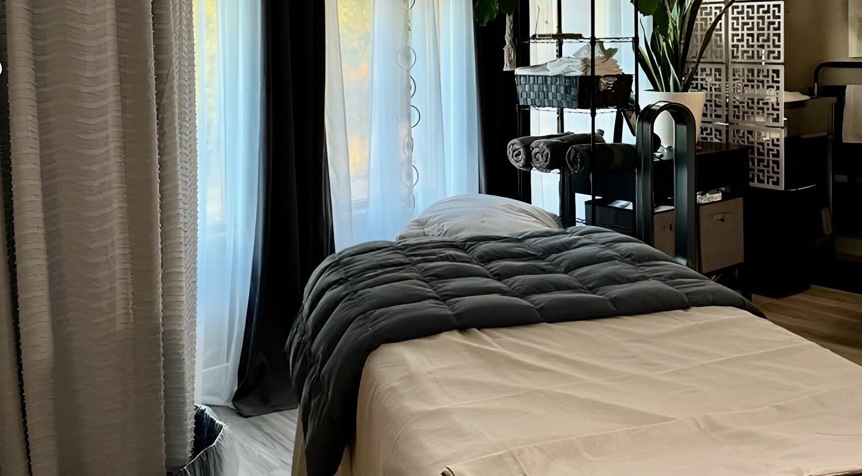 Relaxing massage room at Essential Luxuries Day Spa in Snohomish, Washington, US. Luxurious, calming ambiance.