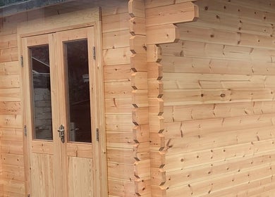 Charming wooden cabin exterior at TheBeautyHut in Atherton, England, GB for relaxation and wellness.