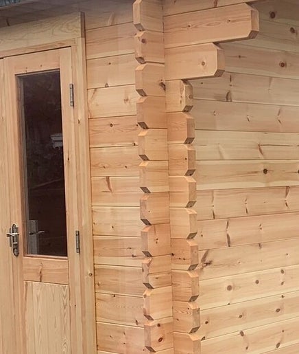 Charming wooden cabin exterior at TheBeautyHut in Atherton, England, GB for relaxation and wellness.