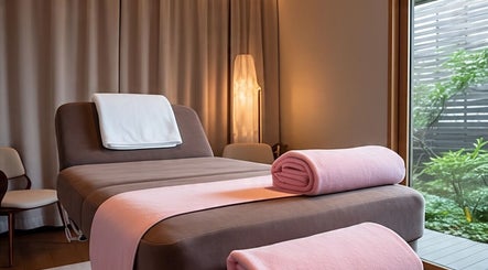 Serene massage room at Lotus Wellnesses in Cape Town, Western Cape, ZA with comfortable bed and soft lighting.
