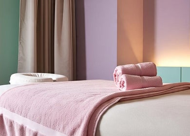 Cozy massage table with pink towels at Lotus Wellnesses, Cape Town, Western Cape, ZA.