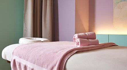 Cozy massage table with pink towels at Lotus Wellnesses, Cape Town, Western Cape, ZA.