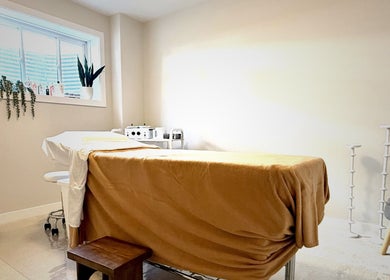 Tranquil treatment room at The Brazilian Bar, Ottawa, Ontario, CA, adorned with soft lighting and cozy furnishings.