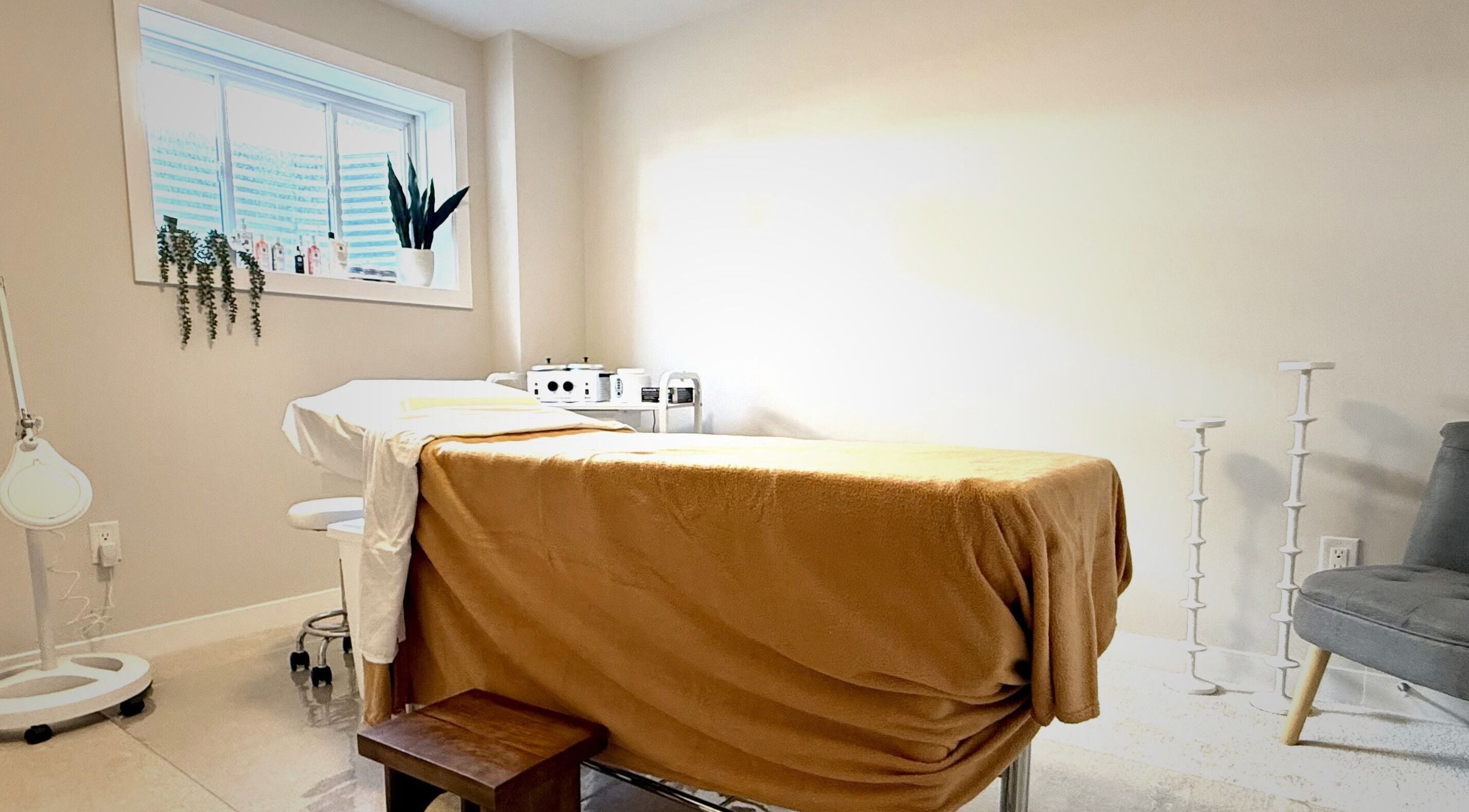 Tranquil treatment room at The Brazilian Bar, Ottawa, Ontario, CA, adorned with soft lighting and cozy furnishings.