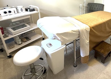 Treatment room at The Brazilian Bar in Ottawa, Ontario, CA, featuring a massage table and waxing supplies.