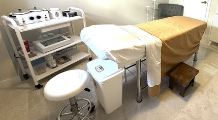 Treatment room at The Brazilian Bar in Ottawa, Ontario, CA, featuring a massage table and waxing supplies.