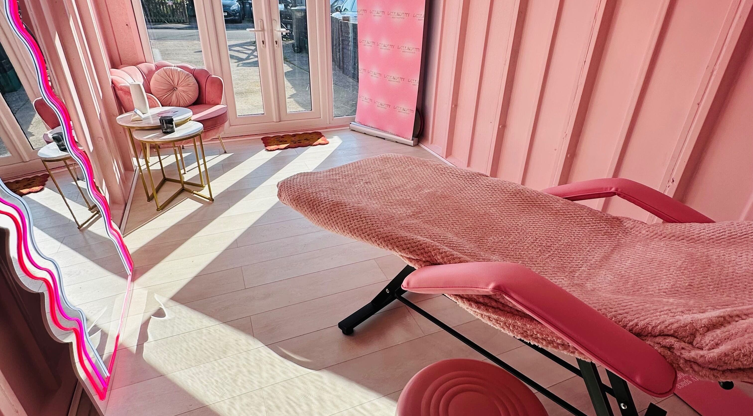 Relaxing treatment space at Doll Beauty Aesthetics & Training Academy, Cleeve, England, GB with pink decor.