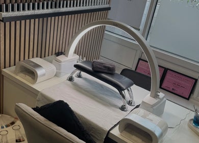 Nail station at Dolly’s Beauty Bar, Newhall, England, GB featuring gel polishes and modern manicure equipment.