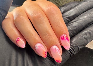 Elegant pink nail art at Dolly’s Beauty Bar, Newhall, England, GB, showcasing intricate design.