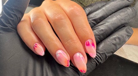 Elegant pink nail art at Dolly’s Beauty Bar, Newhall, England, GB, showcasing intricate design.