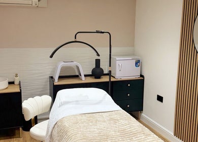 Elegant treatment room at Naked Beauty, North Weald Bassett, England, featuring luxury spa amenities.