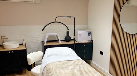 Elegant treatment room at Naked Beauty, North Weald Bassett, England, featuring luxury spa amenities.