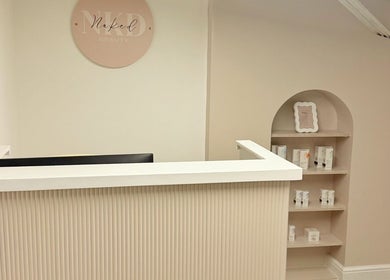 Reception area of Naked Beauty in North Weald Bassett, England, GB with elegant decor and product display.